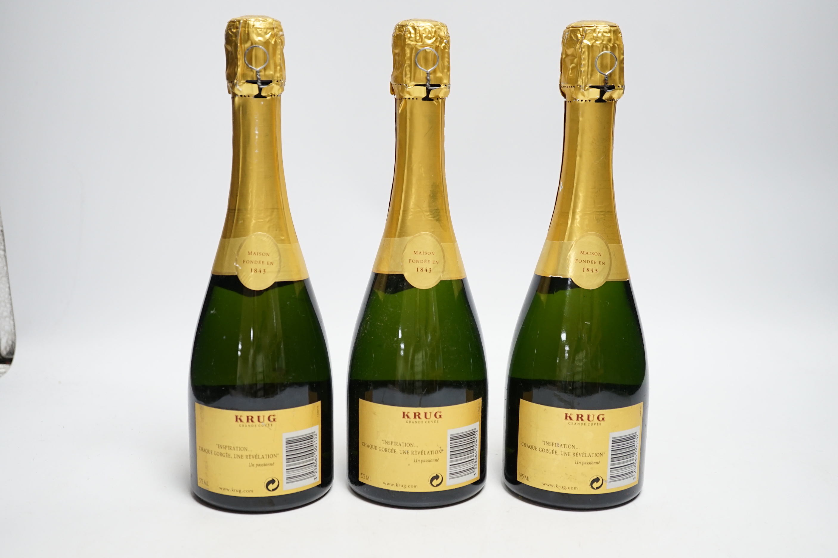 Three half bottles of Krug Grande Cuvee Champagne.